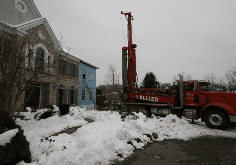 Wells being drilled for the ground-source heat pump. The exterior insulation, an excellent thermal break, wasn't mentioned in the original article.