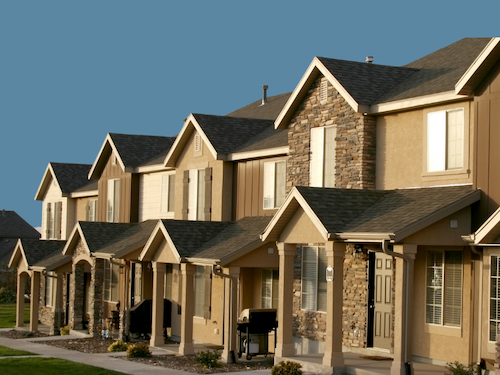 A row of beige townhouses