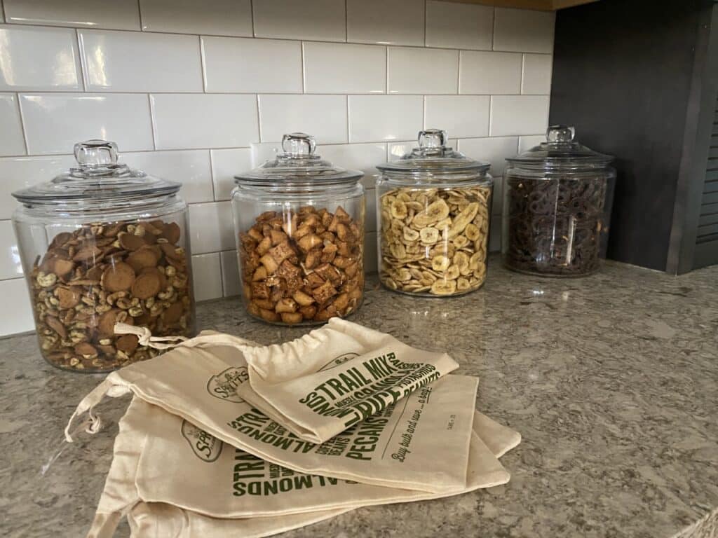 Row of reusable jars fill with bulk snacks in the SK Collaborative office.