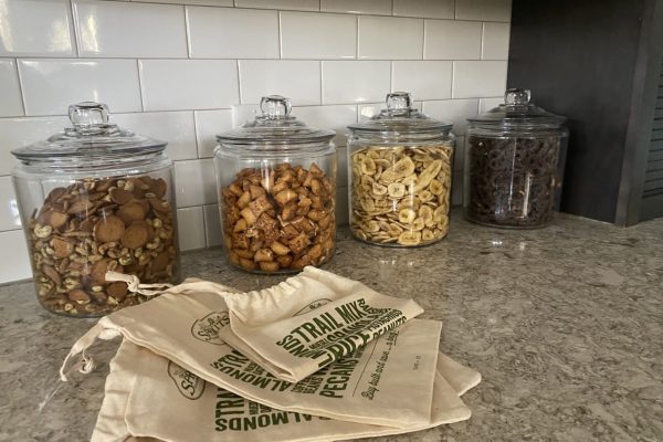 Row of reusable jars fill with bulk snacks in the SK Collaborative office.